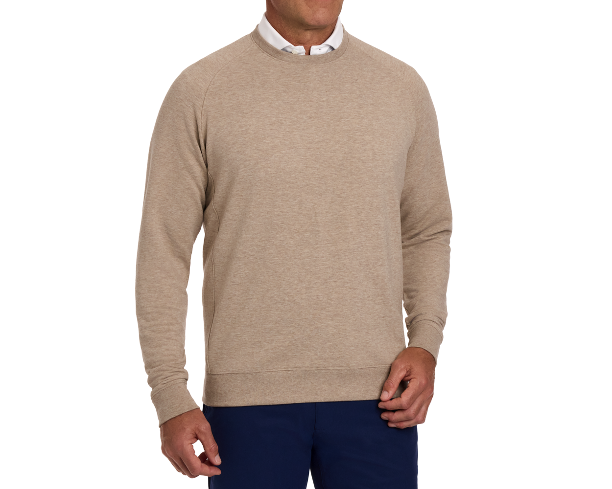 The Kennedy Crewneck: Heathered Dune, shown over a white collared shirt, offers a natural look with its soft terry interior and shape-retaining cotton blend.