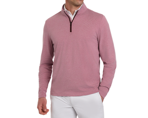 Man wearing The Royce Quarter-Zip: Heathered Cabernet, a slim-fit, rose-pink micro-textured knit pullover, over a white polo, paired with light trousers.