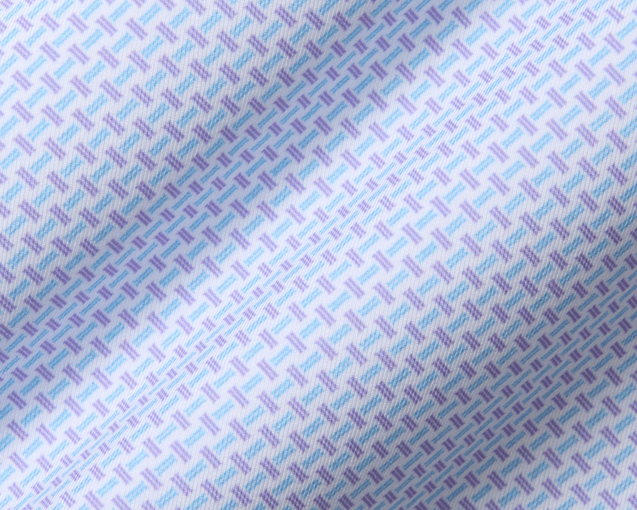 Close-up of The Norman Shirt: Vista Blue & Tudor, showcasing its purple and light-blue basketweave pattern. Designed for performance with UPF 50+ protection and four-way stretch.