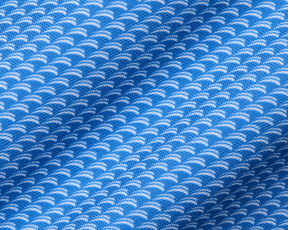 The Eaton Shirt: Horizon Blue, showcasing a close-up of its soft, stretchy fabric with a white, semi-circular wave pattern, designed for moisture wicking and sun protection.