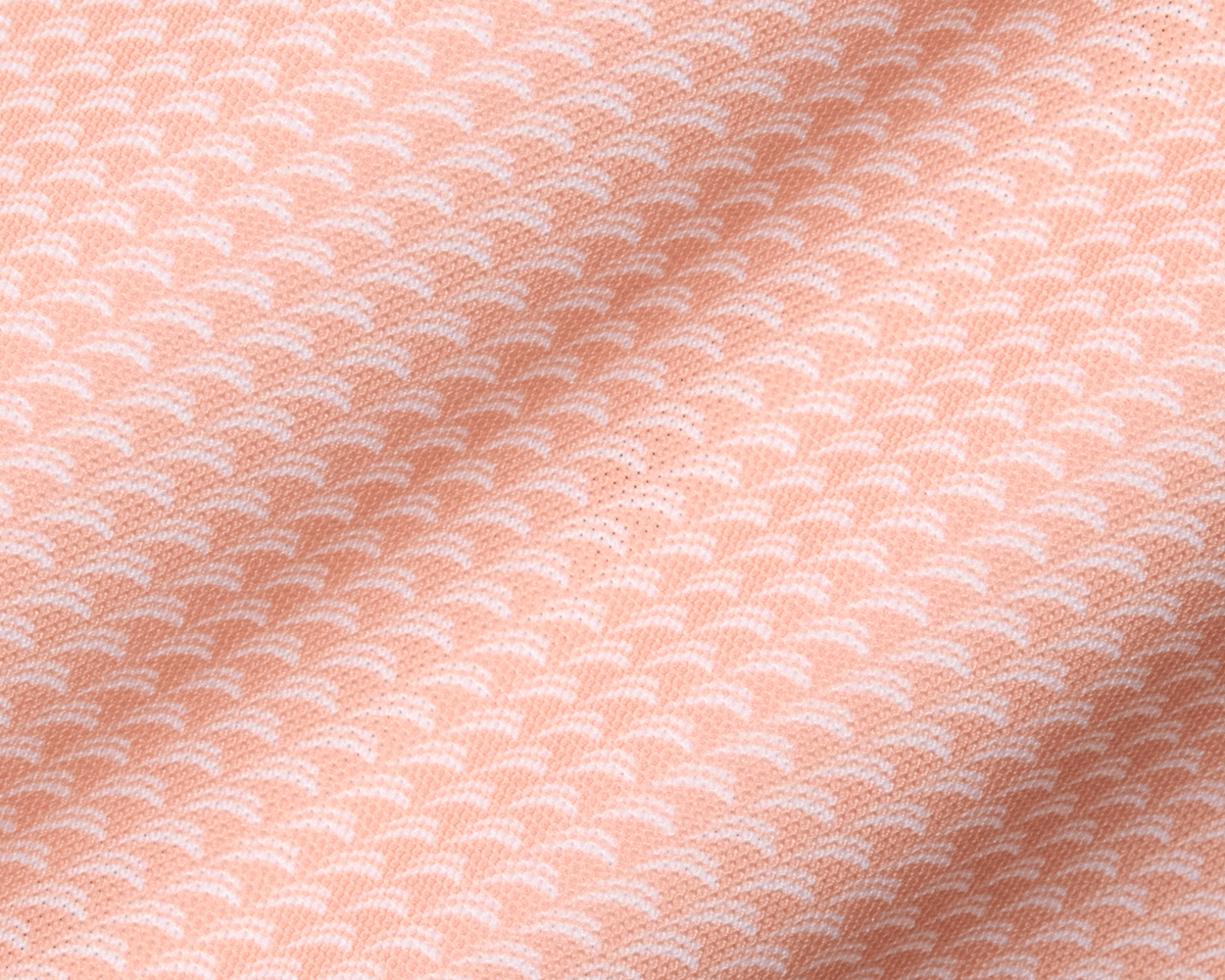 The Eaton Shirt: Nectarine, featuring a soft, peach-hued textile with a subtle wave pattern, designed for comfort, air circulation, moisture wicking, and sun protection.