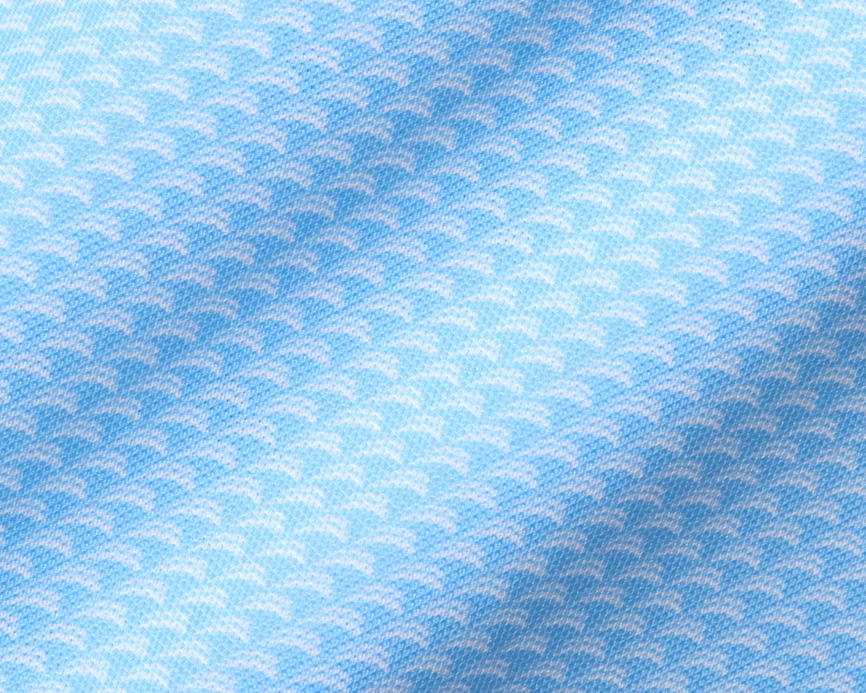 Close-up of The Eaton Shirt: Vista Blue, showcasing its light-blue textile with a scallop pattern, highlighting its soft, stretchy fabric for moisture wicking and sun protection.