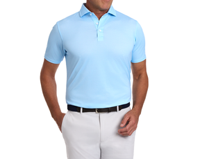Man wearing The Eaton Shirt: Vista Blue, a light-blue polo with abstract wave pattern, dark belt, tucked into light trousers, highlighting its structured collar and fit.