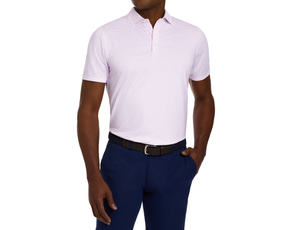 The Cadogan Shirt: Belmont & Horizon Blue features a light-pink, micro-print polo shirt, tucked into navy trousers with a black woven belt.