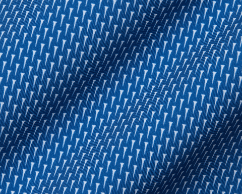 Close-up of the 2026 U.S. Open Hicks Shirt: Maidstone Blue, showcasing its blue fabric with a white geometric pattern, detailed knit texture, and gentle folds.