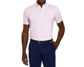 Model wearing The Atwood Shirt: Belmont, a light-pink short-sleeve polo with a structured spread collar, paired with dark navy trousers and a woven belt.