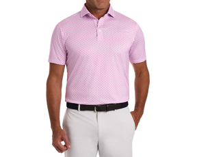 Model wearing The Berkeley Shirt: Cabernet, a light pink polo with a bull-and-bear pattern, paired with light pants and a dark woven belt.