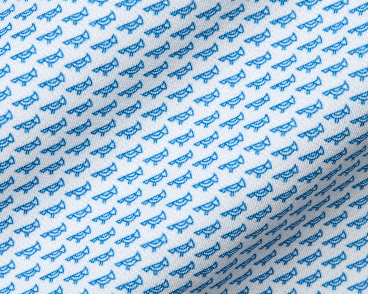 The Walton Shirt: Maidstone Blue features a white fabric with small blue bird pattern, crafted from AIRATION® fabric with a structured spread collar.