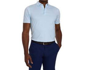 Man wearing The Walton Shirt: Maidstone Blue, a light-blue polo with geometric print, tucked into navy trousers, showcasing AIRATION® fabric's breathability and comfort.