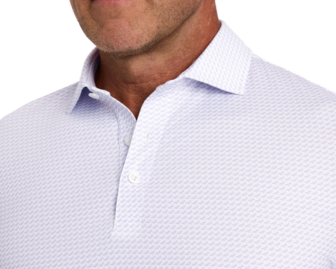 The Walton Shirt: Tudor features a light polo with a small pattern, two-button placket, pointed collar, and visible stubble on chin and neck.
