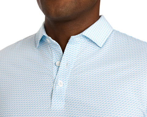 The Walton Shirt: Vista Blue, featuring a light-colored polo with a blue motif, pointed collar, and three buttons, made from breathable, moisture-wicking AIRATION® fabric.