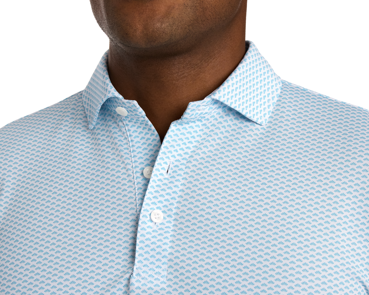 Person wearing The Geiger Shirt: Harbor, featuring a white collared button-front with a light-blue geometric pattern, showcasing its breathable, moisture-wicking pique fabric.