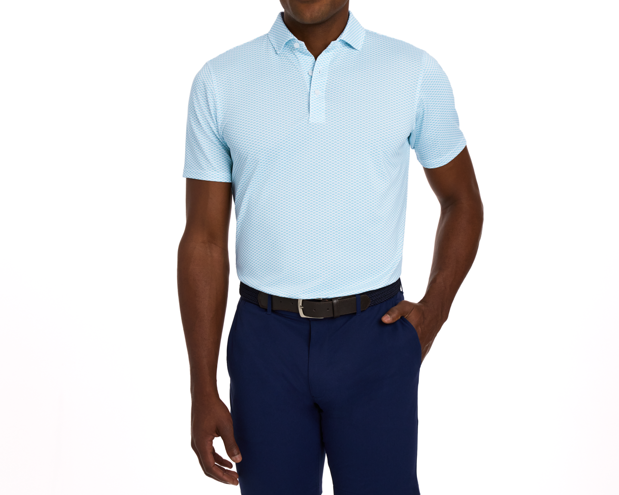 Man wearing The Geiger Shirt: Harbor, a light-blue polo with a repeating abstract pattern, tucked into navy trousers, showcasing its structured spread collar and signature fit.