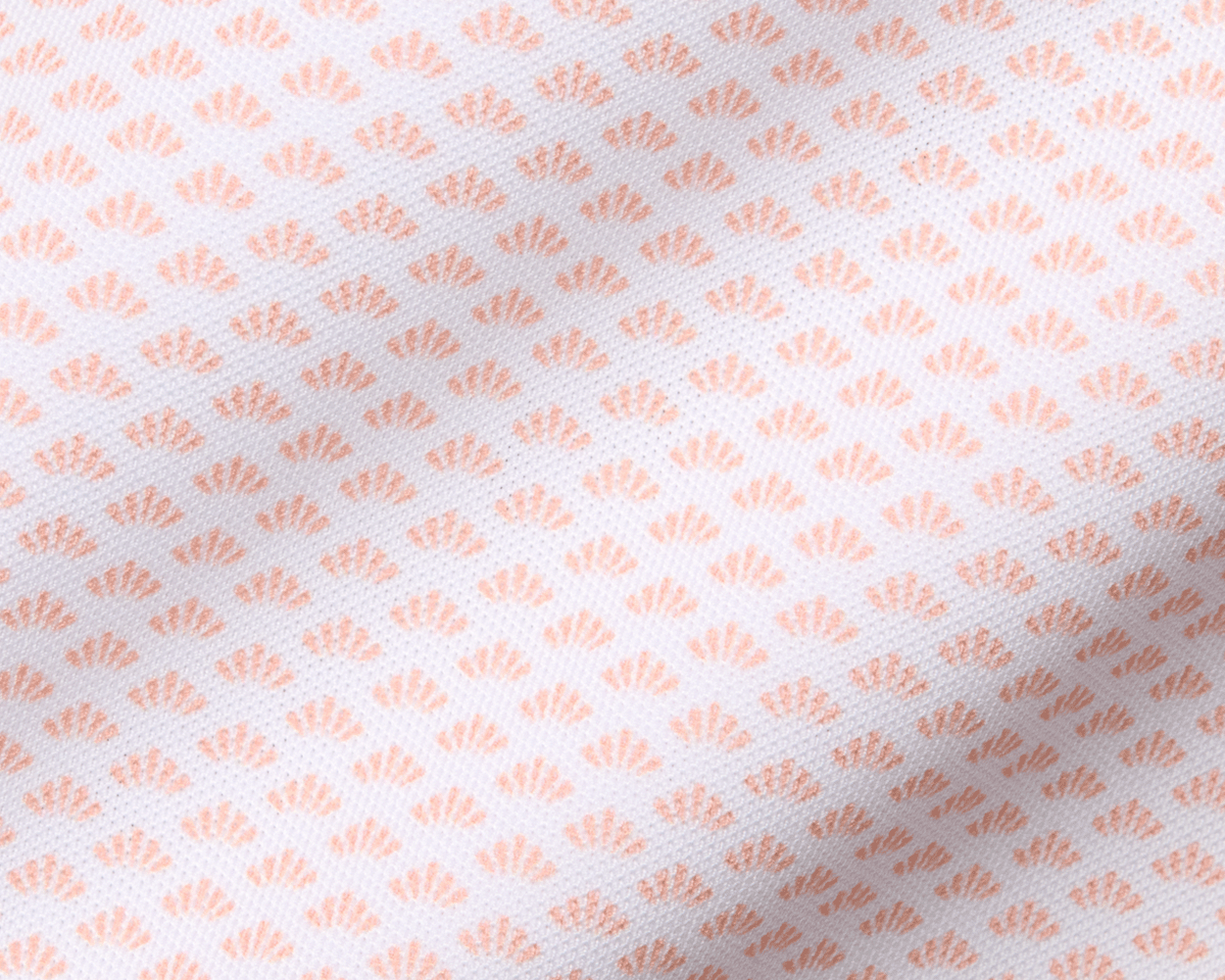 The Geiger Shirt: Nectarine features a white woven fabric with a repeating peach fan motif, highlighting its breathable, moisture-wicking pique texture and structured collar.
