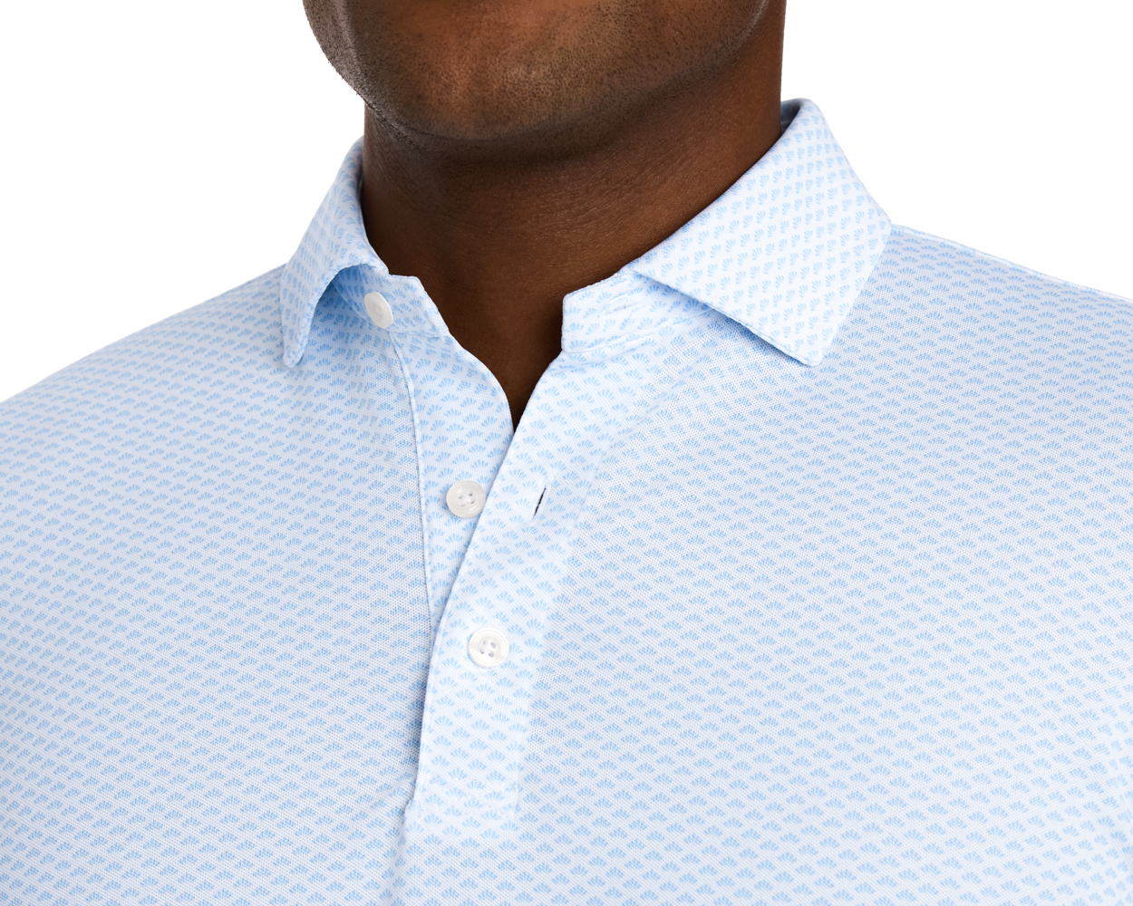 The Geiger Shirt: Vista Blue features a light blue polo with a subtle abstract pattern, classic collar, and three-button placket, highlighting its breathable, stretchy fabric.