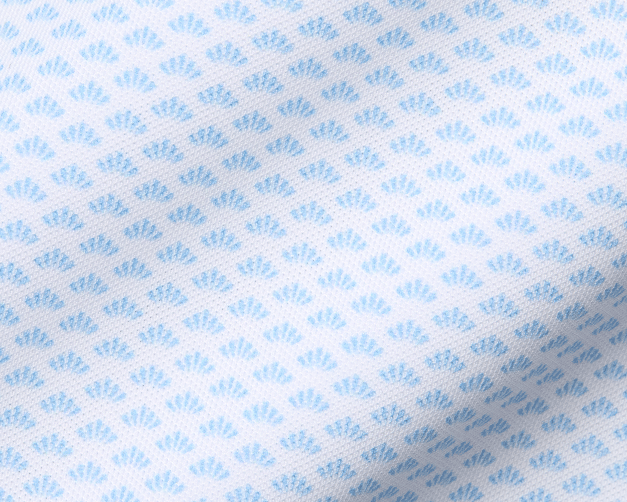 The Geiger Shirt: Vista Blue features a white, mesh-like fabric with a pale-blue fan motif, ideal for moisture-wicking and breathable performance.