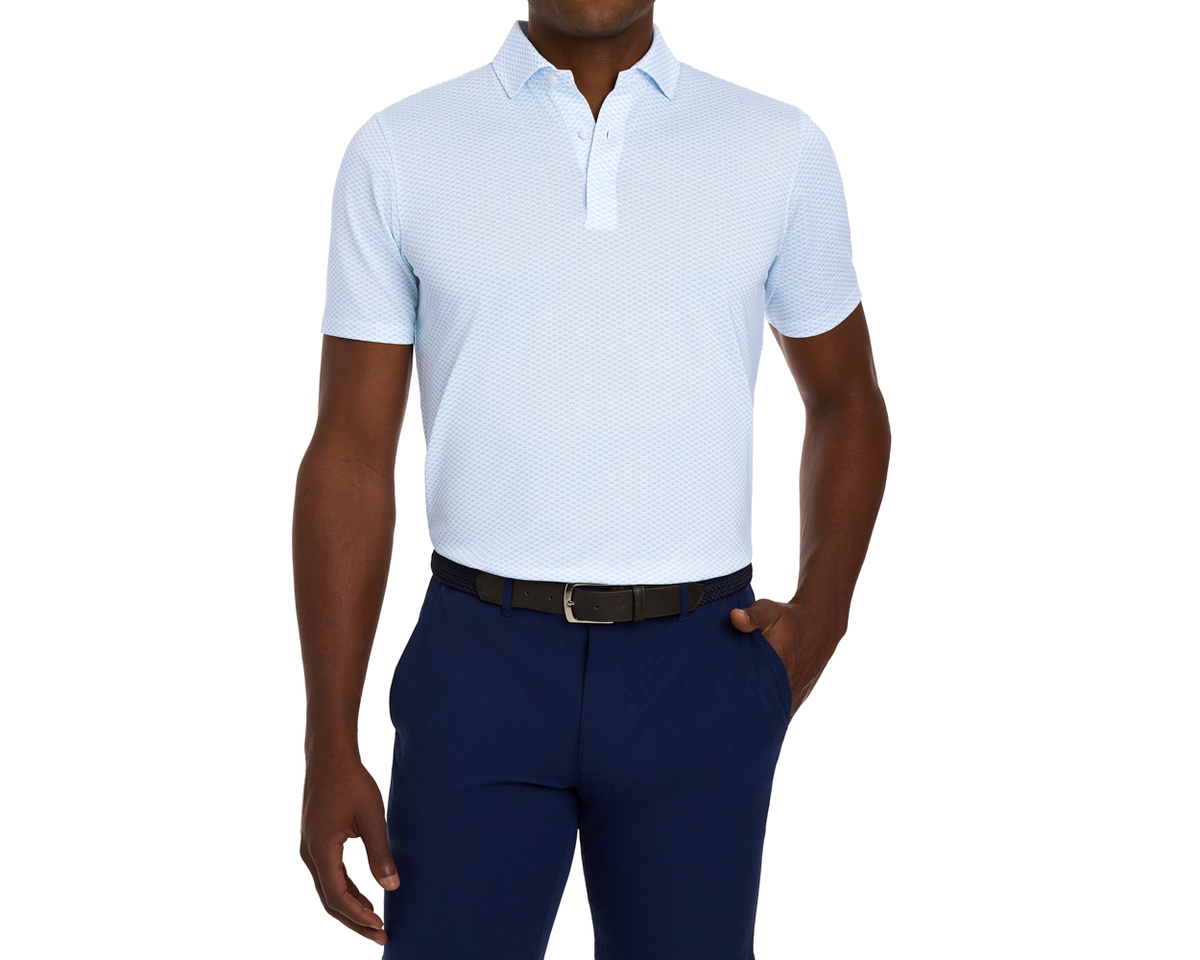 The Geiger Shirt: Vista Blue, featuring a light-blue short-sleeve polo with an abstract pattern, black belt, and navy trousers, offers breathable comfort and UPF 30+ protection.