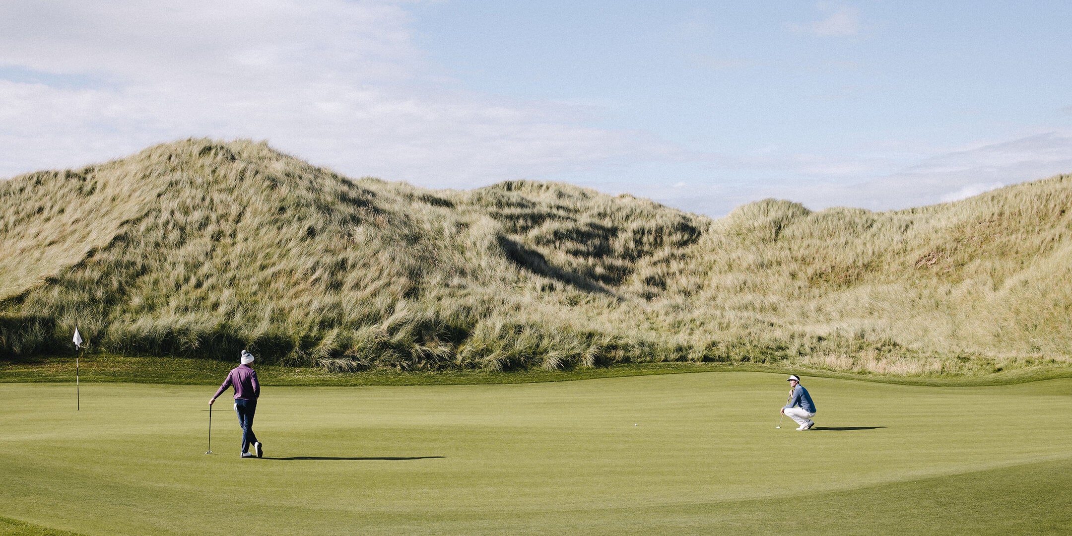 two golf players playing golf on a golf course