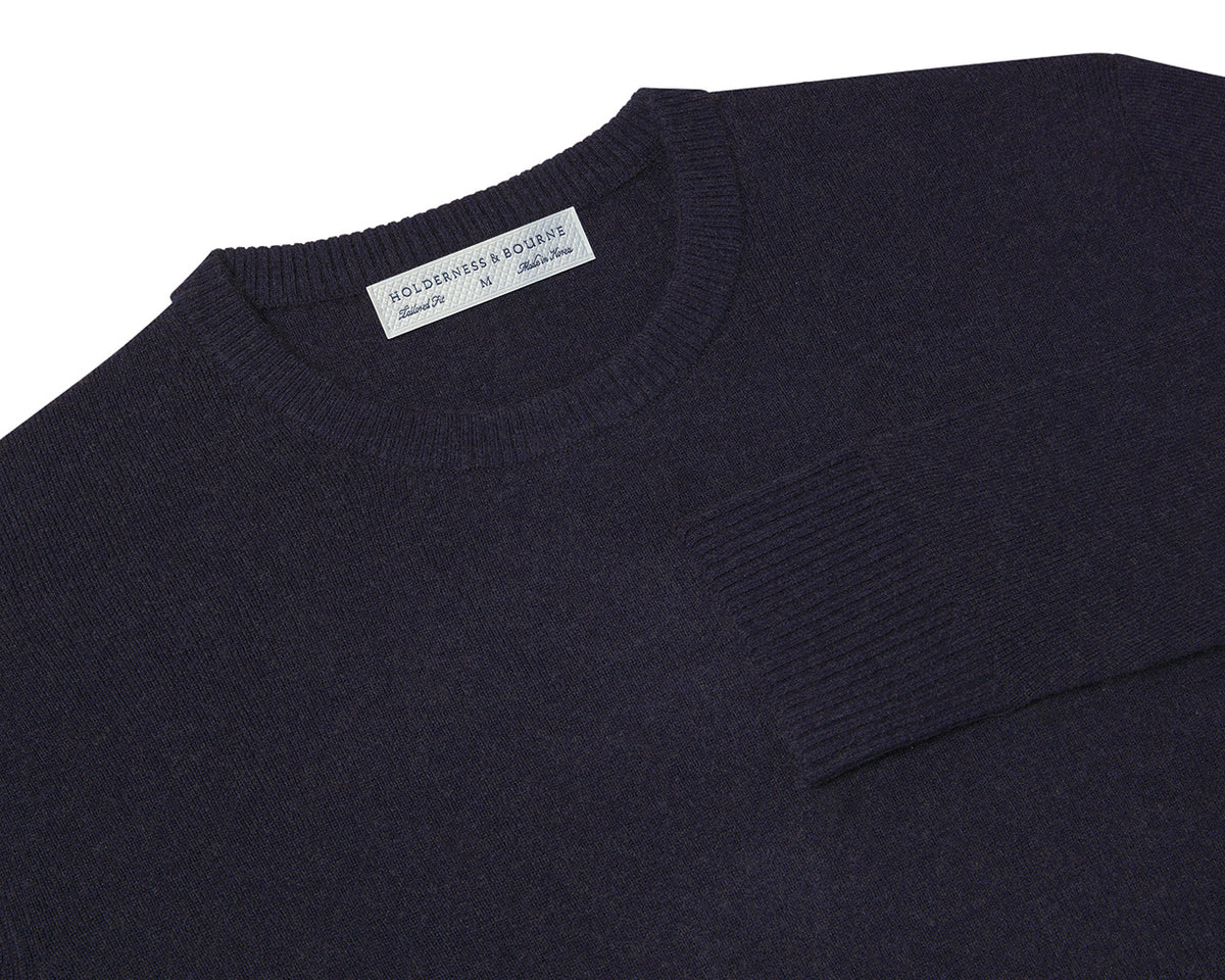 Folded Holderness and Bourne navy Merino & cashmere golf sweater.