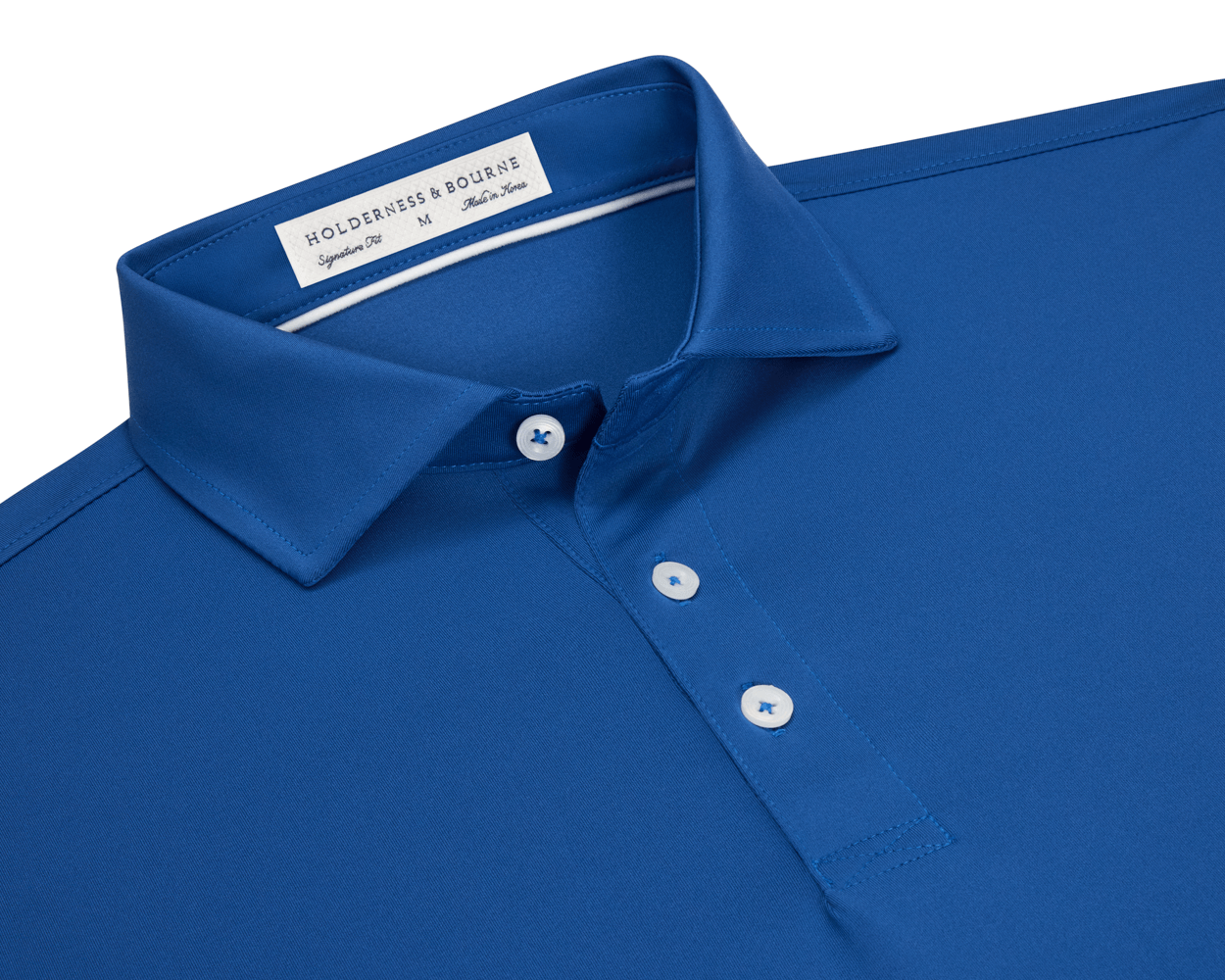 The Anderson Shirt: Maidstone Blue, a short-sleeve polo with a folded collar, three white buttons, and an inside label, offers stretch and moisture-wicking fabric.