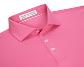 The Anderson Shirt: Belmont, a polo-style with a folded collar, three buttons, and “Holderness & Bourne” label, offers stretch and moisture-wicking performance fabric.
