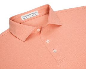 The Holland Shirt: Heathered Nectarine, a medium polo featuring micro-stripes, classic soft collar, and three-button placket, crafted in lightweight fabric for comfort.