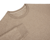 The Kennedy Crewneck: Heathered Dune features raglan sleeves, a round neckline with a printed label, and a soft, heathered cotton-blend fabric.