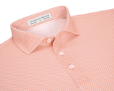The Eaton Shirt: Nectarine, a men’s short-sleeve polo with a textured pattern, classic collar, and three-button placket, offers moisture-wicking and sun protection features.