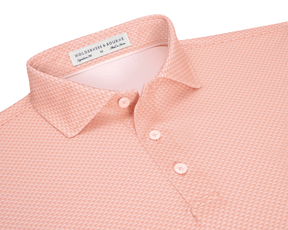 The Eaton Shirt: Nectarine, a men’s short-sleeve polo with a textured pattern, classic collar, and three-button placket, offers moisture-wicking and sun protection features.