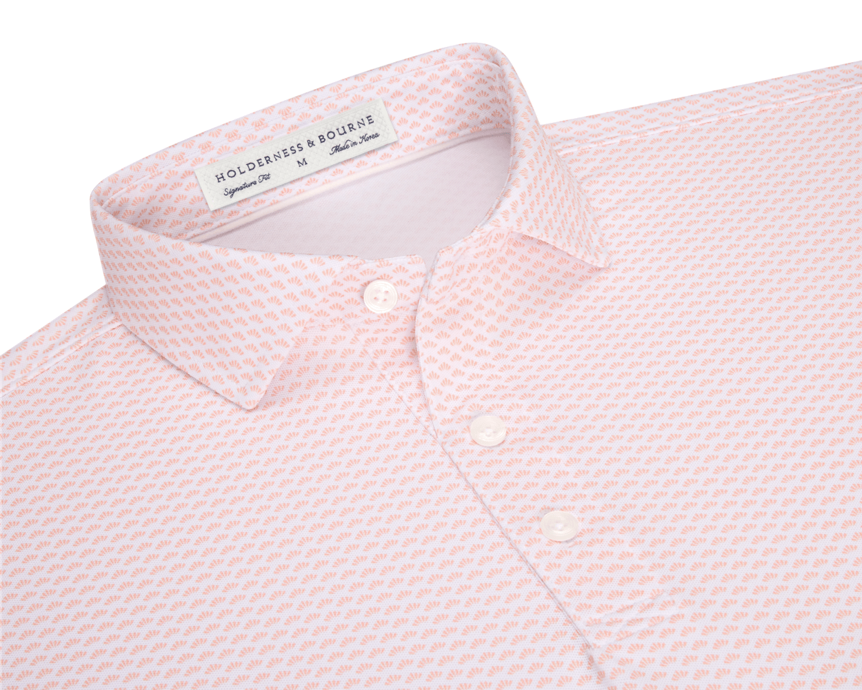 The Geiger Shirt: Nectarine, featuring a tiny orange fan motif, collared with three visible buttons, offers breathable, moisture-wicking performance pique and UPF 30+ protection.