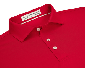 The Anderson Shirt: Liberty Red, featuring a folded collar, three-button placket with white buttons, and Holderness & Bourne label, offers stretch and moisture-wicking performance.