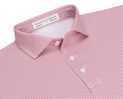 The Armfield Shirt: Liberty Red, featuring a red-and-white geometric print, classic point collar, three-button placket, and Holderness & Bourne label, ideal for golfing performance.