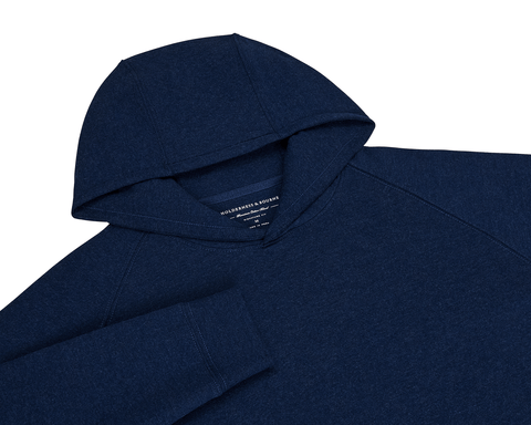The Lawson Hoodie: Heathered Atlantic, a dark navy pullover with raglan sleeves and cuff, features an ultra-soft fabric and minimalistic design.