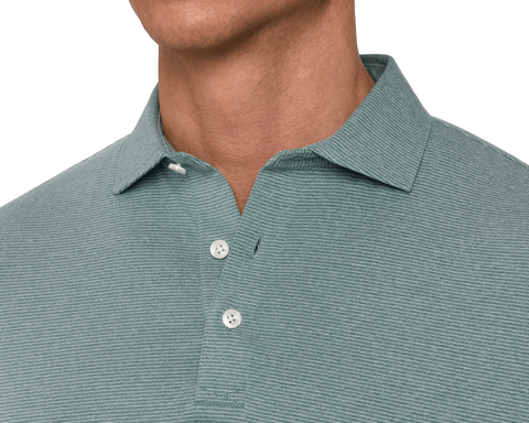Close-up of a male model wearing The Holland Shirt: Heathered California Spruce, showing the spread collar, three-button placket, and subtle repeat stripe.