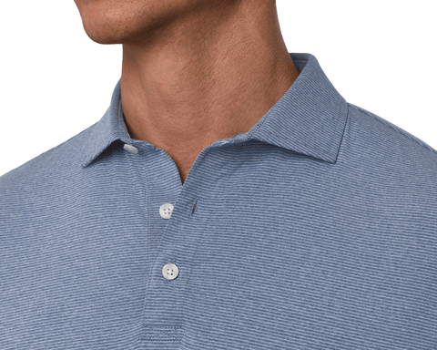 Close-up of a male model wearing The Holland Shirt: Heathered Pacific Blue, showing the spread collar, three-button placket, and subtle repeat stripe.