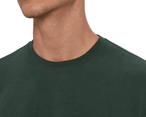 Close-up of a model wearing The Mason T-Shirt: Cypress, detailing the ribbed crew neckline and clean seams at the shoulder.