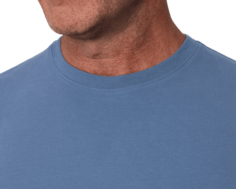 Close-up of a model wearing The Mason T-Shirt: Pacific Blue, detailing the ribbed crew neckline and flat-stitched collar.