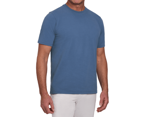 Model wearing The Mason T-Shirt: Pacific Blue, a short-sleeve crew-neck tee with a relaxed fit, paired with white pants.