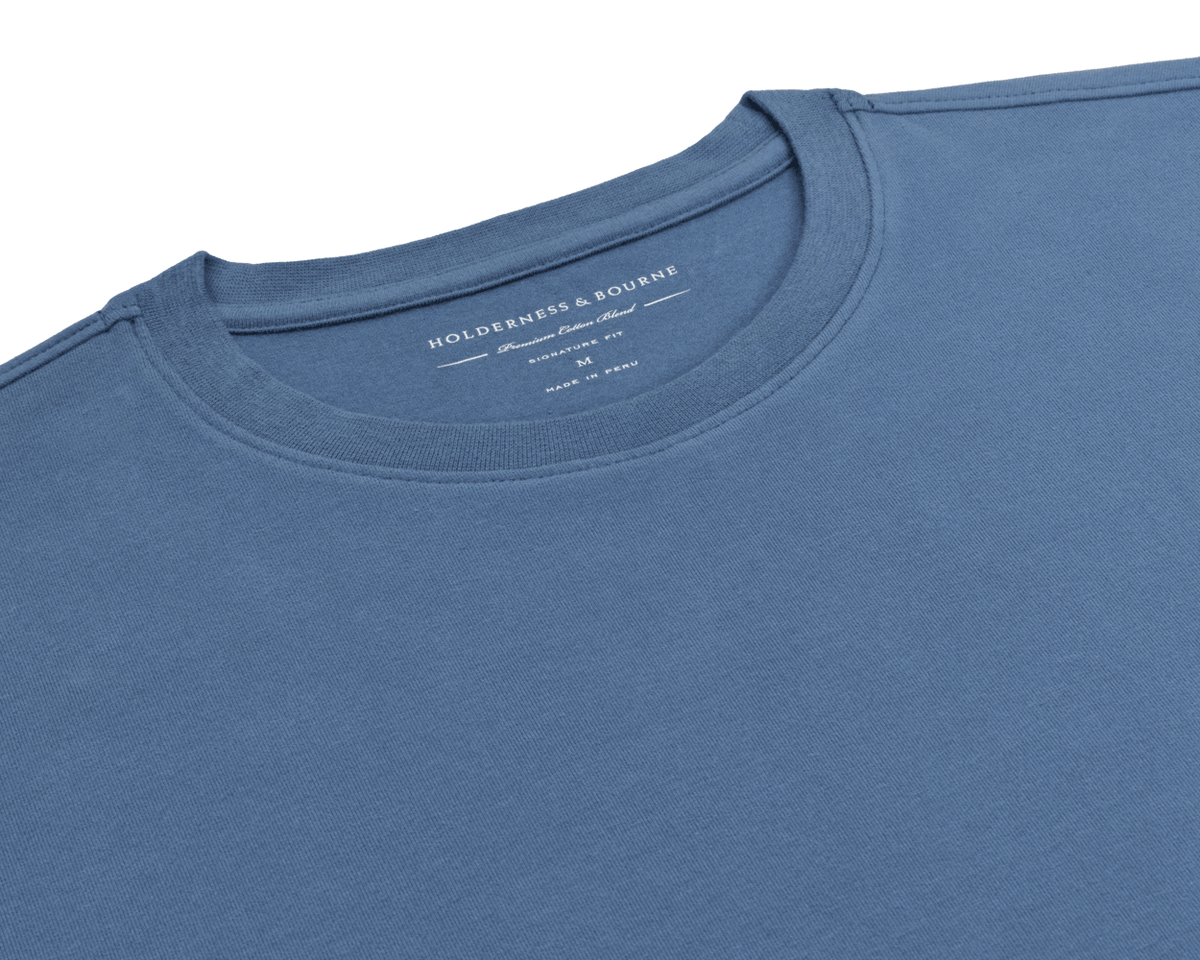 The Mason T-Shirt: Pacific Blue flat-lay showing its ribbed crew neck and Holderness & Bourne Premium Cotton Blend label, made in Peru.