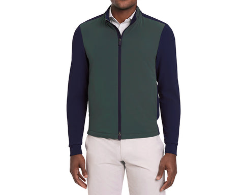 Green and navy long-sleeve golf jacket worn by a person on a white background