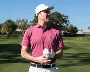 A man on a golf course wears the 2026 U.S. Open Macdonald Shirt, featuring a structured spread collar and breathable performance pique design.