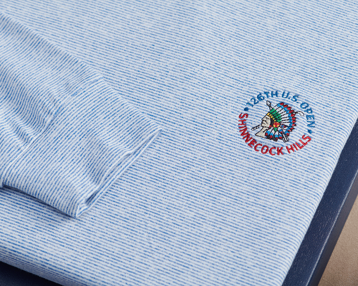 2026 U.S. Open Hamilton Pullover: Heathered Maidstone Blue & White, featuring a light-blue-and-white micro-striped pattern and embroidered U.S. Open logo on the chest.