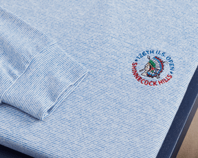 2026 U.S. Open Hamilton Pullover: Heathered Maidstone Blue & White, featuring a light-blue-and-white micro-striped pattern and embroidered U.S. Open logo on the chest.