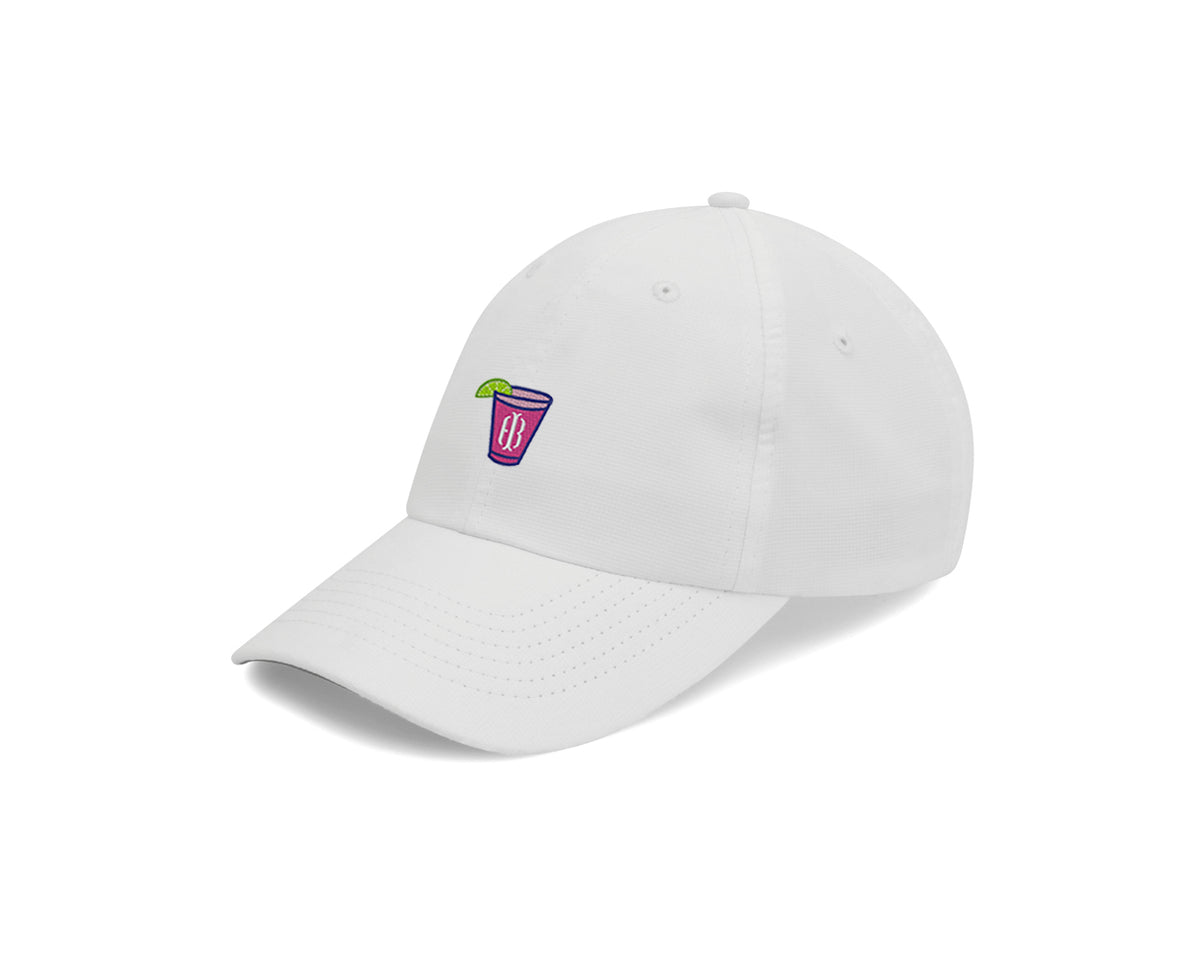 White transfusion hat with pink Holderness and Bourne embroidered cocktail logo angled to the left.