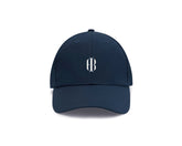 White and navy hat with white Holderness and Bourne embroidered logo.