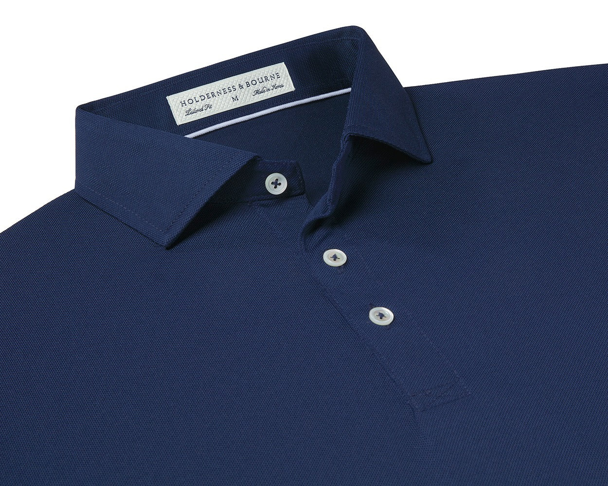 Folded Holderness and Bourne navy blue golf shirt.