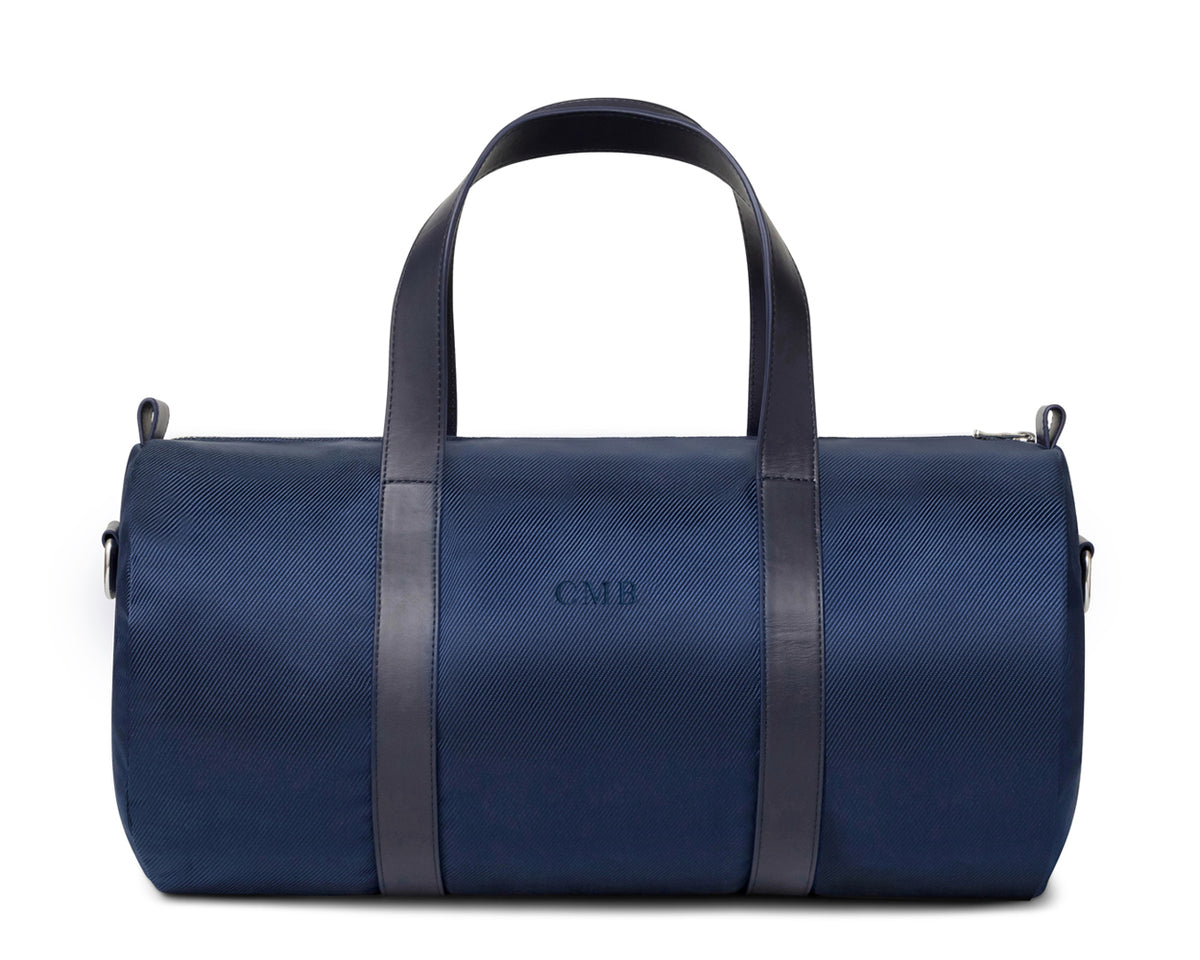 Blue banker bag with dark leather straps and embroidered lettering from Holderness and Bourne.