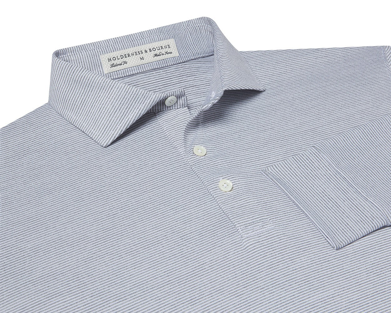 Folded Holderness and Bourne grey and white striped polo shirt.