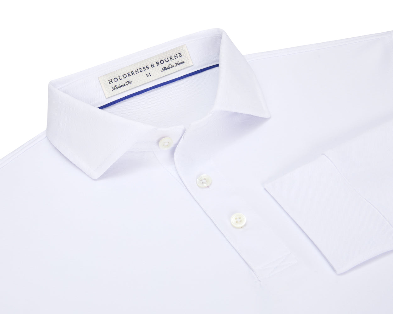 Folded Holderness and Bourne mens white long sleeve polo.