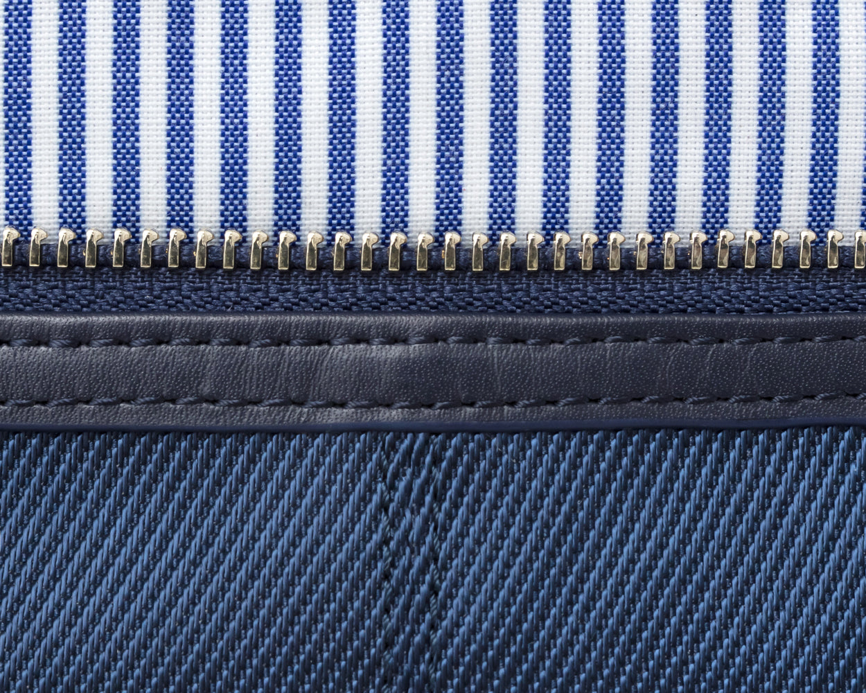 Close up on inside of navy Holderness and Bourne dopp bag.